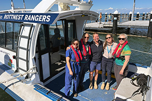 A group of five women stand on the deck of the Rottnest Rangers rescue. Three women wear a lifejacket