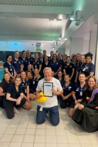 Eric Watson pictured front centre, surrounded by 31 of his colleagues.