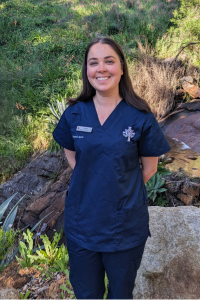 Taryn at age 31 in her blue nursing uniform.