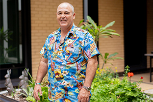 Cameron Briscoe stands in an outside area wearing a colourful shirt