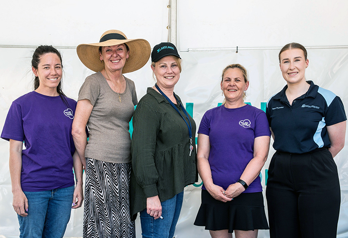 Five representatives from Act Belong Commit, Lakelands Shopping Centre, City of Mandurah and SMHS Health Promotion team stand together at the Spring into Life event.