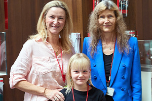 Genevieve Hodgson (back left) stands with her arm on the shoulder of her young daughter Asha. Standing beside them is MED-EL Implant Systems CEO, Dr Ingeborg Hochmair.