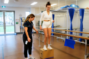 Gracie completing some rehabilitation exercises alongside a physiotherapist. 