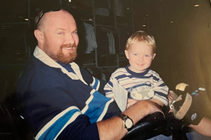 Gregory pictured with his three-year-old son sitting on his lap. 