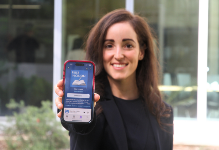 FSH Colorectal Fellow Dr Amanda Nikolic holding up a phone in front of her with her podcast on display.