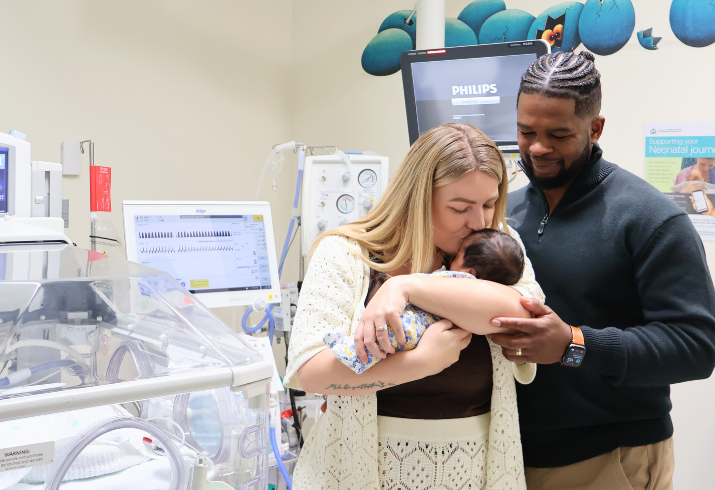 Kiera and John holding baby Athena on neonatal ward at FSH