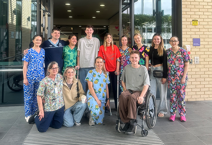 Matt pictured outside the FSH SRS with his rehab team and other patients