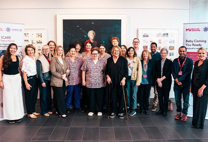 Twenty staff from the Fiona Stanley Hospital maternity team and the Ngangk Yira Institute for Change from Murdoch University standing together. 