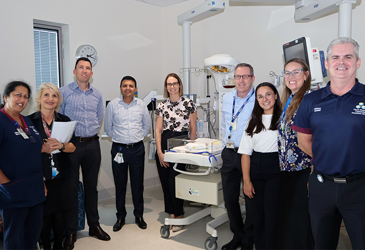 Group photo of medical imaging and paediatric staff with Mineral Resources and Telethon guests within a paediatric hospital room.
